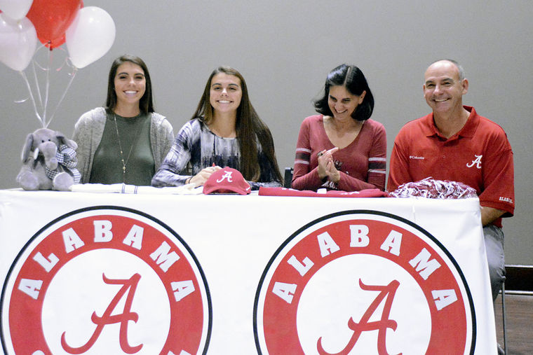 Cullman's Claire Jenkins (left center) flashes a mile-wide grin after signing a National Letter of Intent to attend and play softball for the University of Alabama. Joining her is sister Jennifer (left) and parents Martha and Rodney. 11-13-15